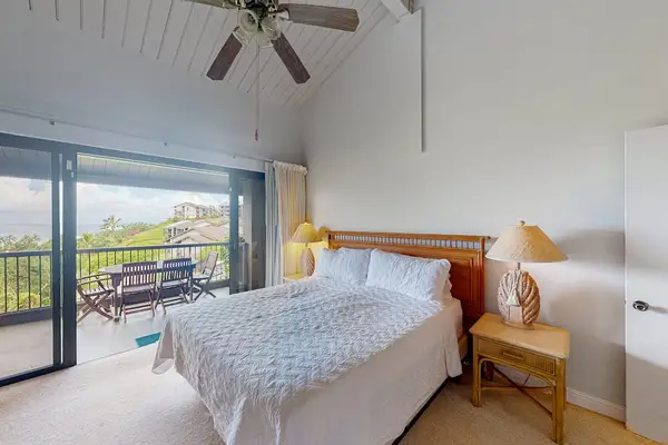 Bedroom retreat features king bed warm accents and gentle daylight