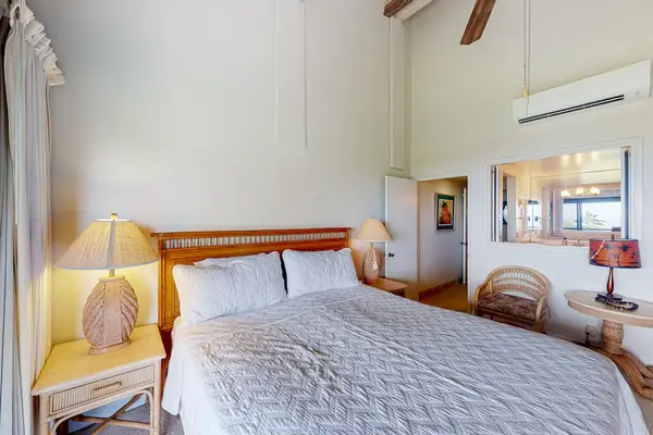 King bed fills loft bedroom with seating and tropical accents