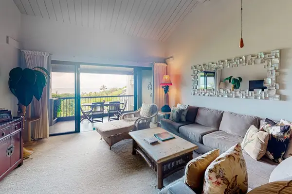Living room comfortable seating beside ocean facing glass doors
