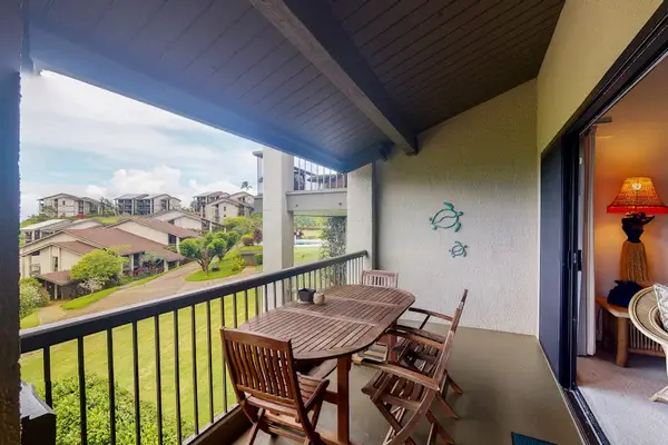 Covered balcony dining overlooks resort grounds mountains and island views