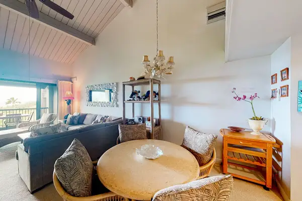 Contemporary lounge provides comfortable seating beneath elegant island artwork today