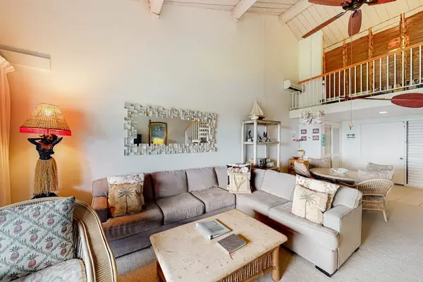 Living room seating frames artwork sunshine and inviting open windows