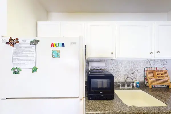 Enjoy cooking in this kitchen featuring a large refrigerator and practical modern amenities
