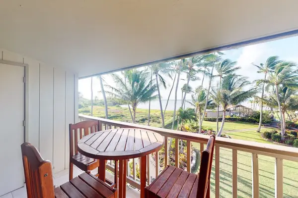 Lush resort grounds feature palms pathways and scenic island views