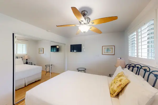 Comfortable bedroom offers a ceiling fan and welcoming space for peaceful sleep daily