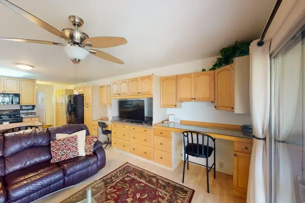 Living area and kitchen offer comfortable seating with island dining