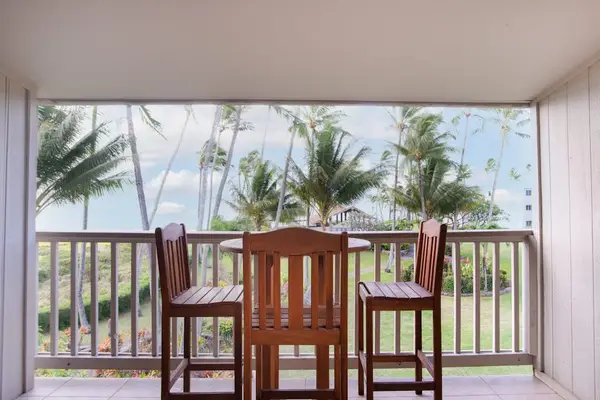 Balcony dining area offers ocean views and comfortable outdoor seating