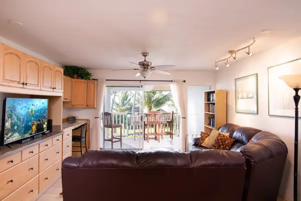 Floor to ceiling glass walls fill the living room with light and balcony views