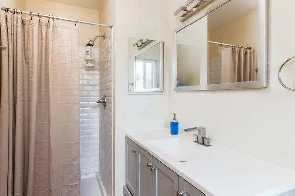 Full bathroom with walk-in shower.