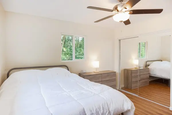 Guest room with double bed and a ceiling fan.