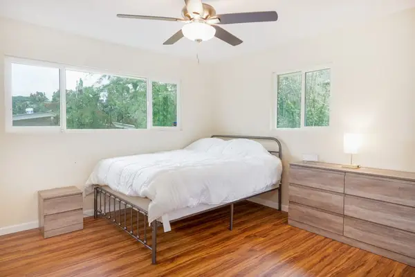 Guest room with double bed and a ceiling fan for added comfort at night.