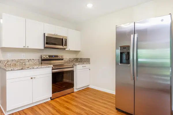 Large kitchen with stainless steel appliances.