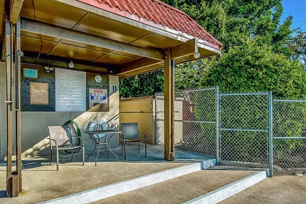 Covered Outdoor Patio with Seating and Shaded Lounging Area