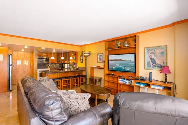 Beautiful wood finishes bring natural charm throughout the inviting living room space