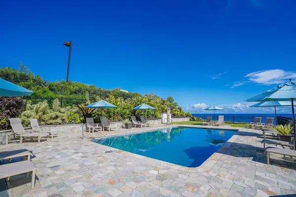Pool area to relax by the water with lounge chairs and umbrellas