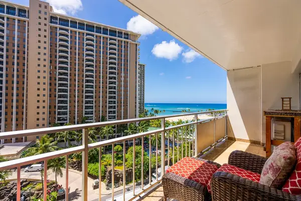 Relax on the cozy balcony overlooking a beautiful partial beach view together