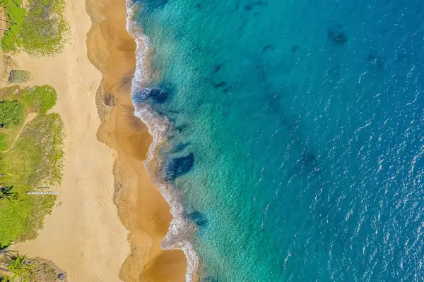 Turquoise Waters And Sandy Shoreline
