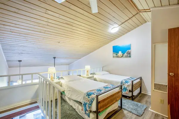 Three single beds located in the loft of the townhome.