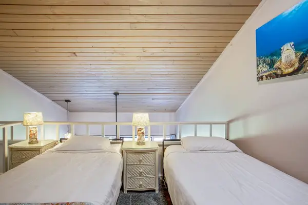Three single beds located in the loft of the townhome.