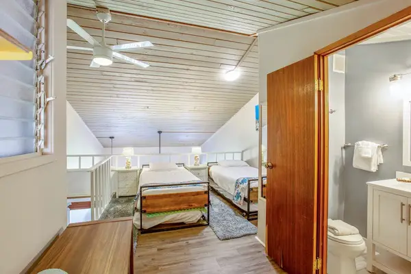 Three single beds located in the loft of the townhome.