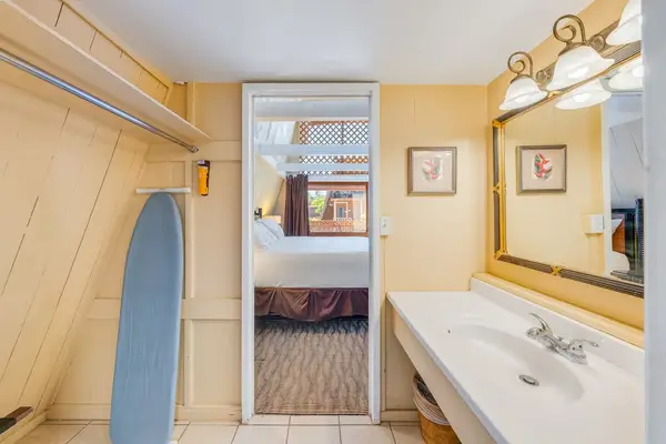 Studio bathroom includes a clean vanity mirror and shower area