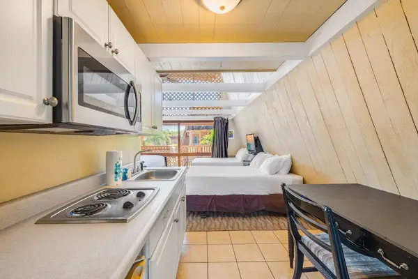Compact kitchen provides counters cabinetry and practical cooking space