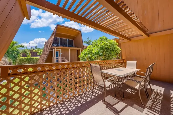 Balcony railing frames vivid ocean views and resort greenery nearby