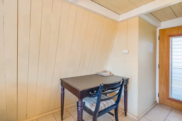 Dining nook offers a compact table beside wood paneling