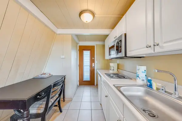 Kitchen counters and cabinets create an efficient studio cooking area