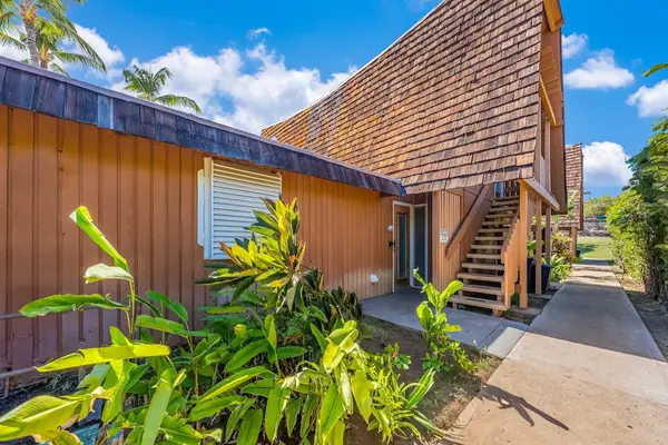 Resort exterior showcases wood architecture palms and welcoming pathways