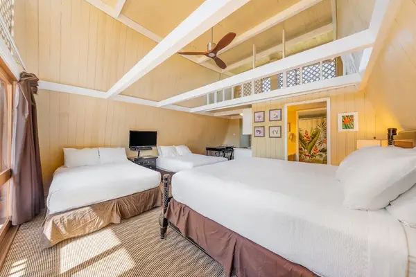 Sleeping area features comfortable bedding and warm wood accents