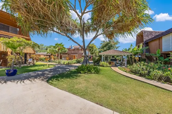 Island pathways offer easy access through bright green resort grounds