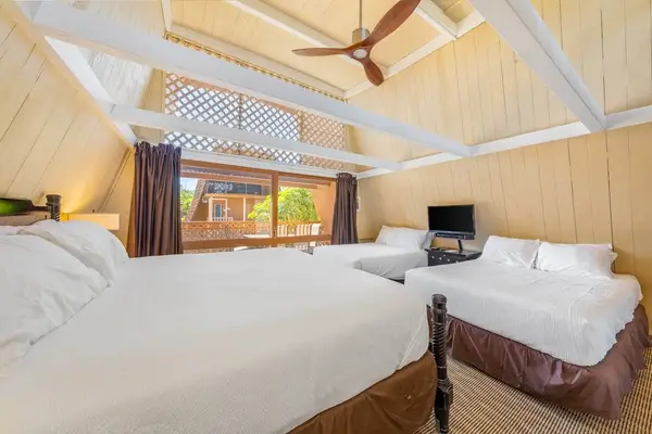 Studio sleeping space includes twin beds ceiling fan and light