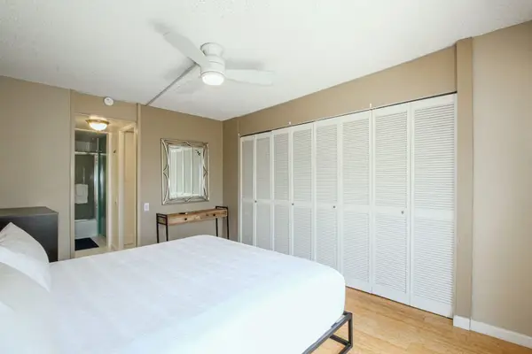 Relax and recharge in a spacious master bedroom designed for comfort and restful nights.