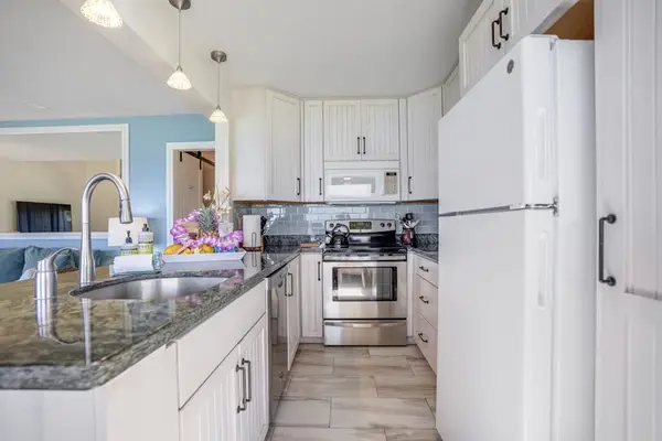 Modern kitchen with stainless steel appliances and ample counter space.