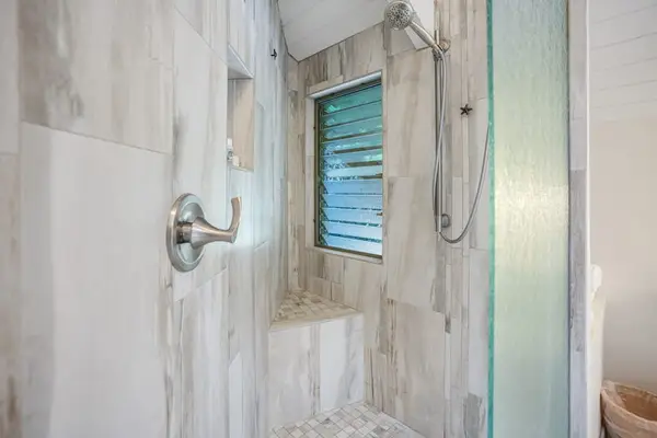 Beautiful walk-in shower with elegant stone tile.