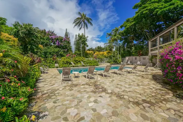Relax on the spacious pool deck surrounded by tropical gardens.