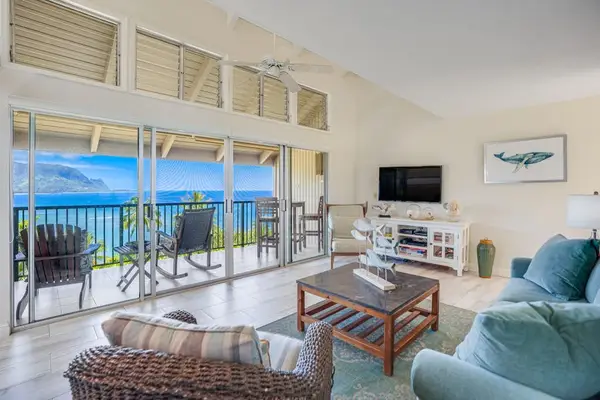 Bright living room with panoramic ocean views and comfortable seating.