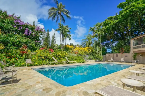 Relax by the resort pool surrounded by lush tropical gardens.