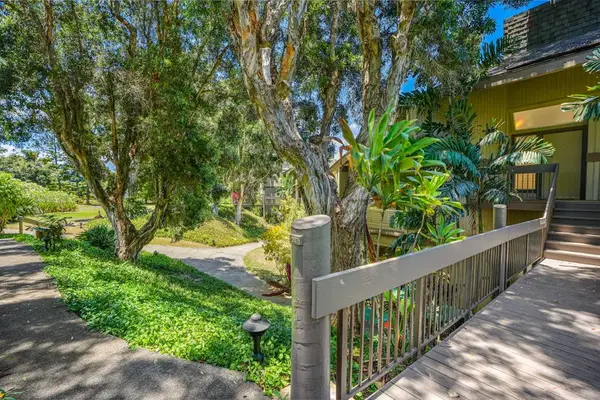 Scenic walkway surrounded by lush tropical landscaping.