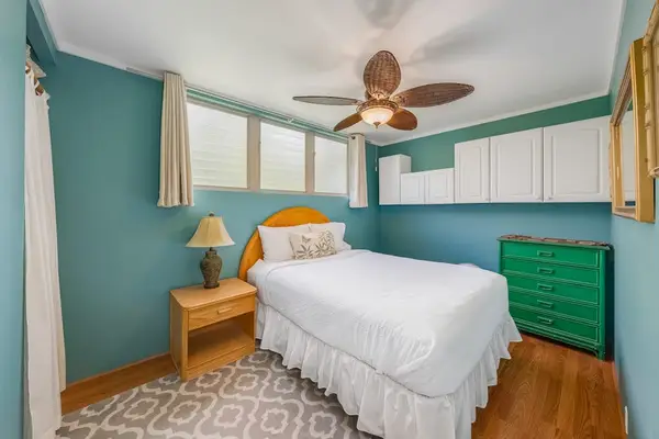 Peaceful bedroom with ceiling fan provides a refreshing setting for restful vacation nights