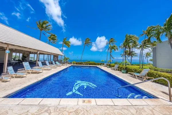 Refreshing resort pool surrounded by tropical scenery perfect for relaxing sunny afternoons together