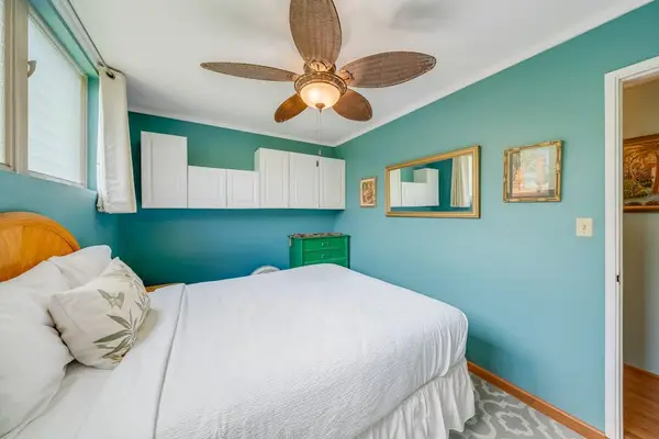Inviting bedroom features a ceiling fan for refreshing comfort after island adventures daily