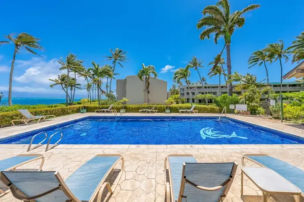 Enjoy relaxing moments at the resort pool surrounded by lush tropical greenery and sunshine