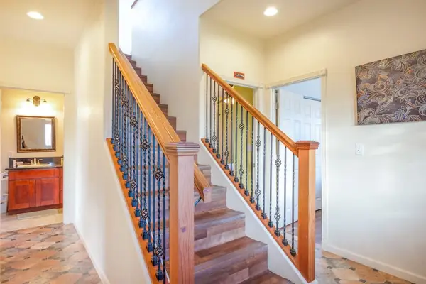 Welcoming Entryway With Open Staircase
