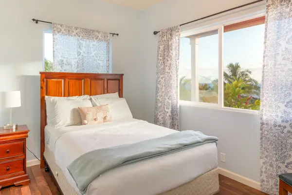 Sunlit Guest Bedroom With Island Views