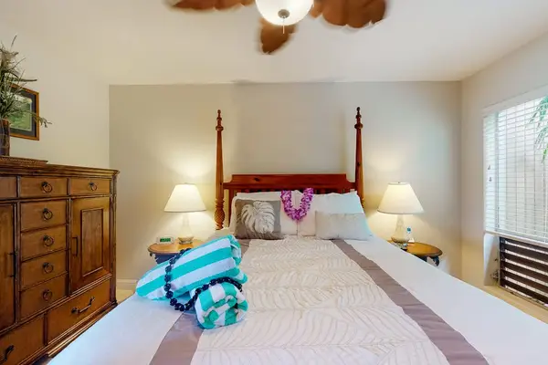 Sunlit bedroom showcases practical furnishings alongside breezy coastal decorative touches