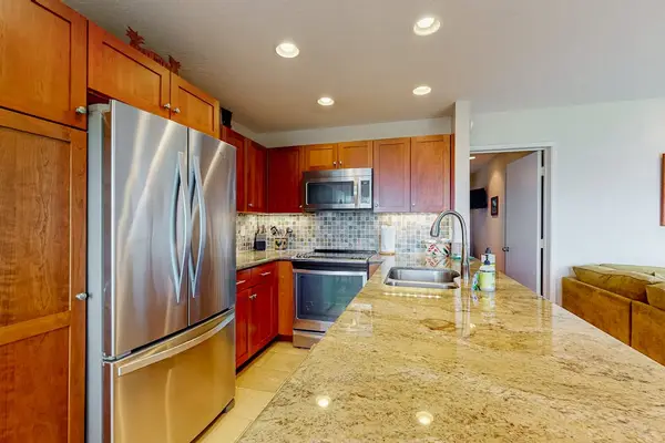 Modern kitchen showcases streamlined cabinetry, useful appliances, and generous counters