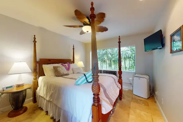 Peaceful bedroom presents layered bedding, tasteful accents, and restful surroundings