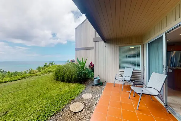 Relaxing patio offers open-air seating overlooking manicured lawns and mountains